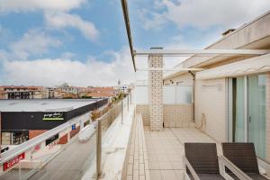 a balcony with chairs and a view of a city at Espinho Retreat with Balcony in Espinho +30 photos