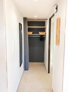 a hallway with a walk in closet with shelves at La terrasse du romarin in Gorges