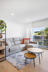 a living room with a couch and two tables at Sunny Stays Espinho | Balcony & Pool in Espinho