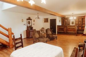 a large living room with a table and chairs at Hanul Pescarilor Crisan in Crisan