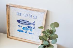 a picture of two fish with the words love as by the sea at Aguda Beach Apartment in Arcozelo +25 photos