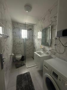 a bathroom with a washing machine and a sink at PRCPORTOapartmani in Herceg-Novi +214 photos