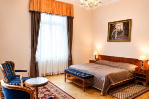 a bedroom with a bed and a large window at Bristol Vila Tereza in Karlovy Vary +43 photos