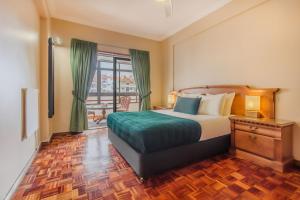 a hotel room with a bed and a balcony at Cantinho em Cascais, Spacious 3BR with Balconies in Cascais
