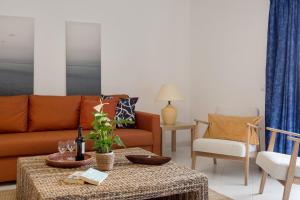 a living room with a couch and a table at Prainha Family Fun | Balcony & Pools in Alvor
