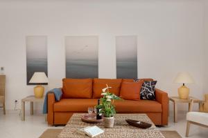 a living room with a couch and a table at Prainha Family Fun | Balcony & Pools in Alvor