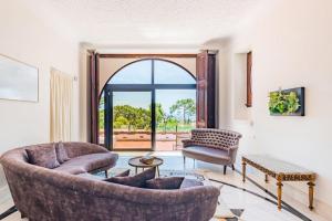 a living room with a couch and a chair at Estoril Royal Atlantic Villa with Ocean View in Estoril