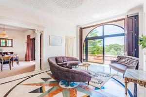 a living room filled with furniture and a large window at Estoril Royal Atlantic Villa with Ocean View in Estoril