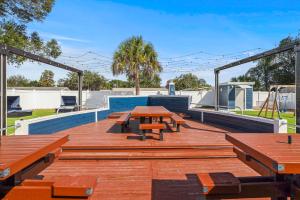 a picnic table and benches on a wooden deck at 2812 Tulane Dr in Cocoa
