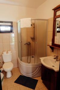 a bathroom with a tub and a toilet and a sink at Hanul Pescarilor Crisan in Crisan +37 photos