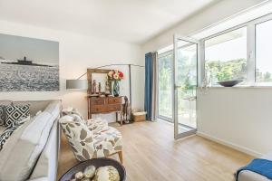 a living room with a couch and a window at Luxury Beach Experience in Lisbon in Oeiras