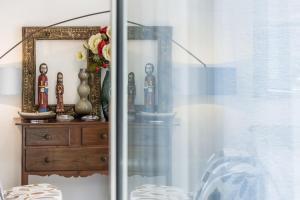 a mirror on a dresser next to a window at Luxury Beach Experience in Lisbon in Oeiras
