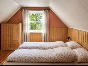 a bedroom with two beds and a window at 6 person holiday home in Leikanger in Leikanger