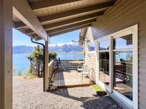 a porch of a house with a view of the water at 6 person holiday home in Leikanger in Leikanger