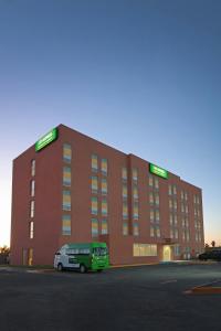 a building with a van parked in front of it at City Express Junior by Marriott Mexicali in Mexicali