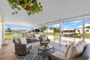 a living room with couches and chairs and a pool at 1480 W Riviera Dr in Merritt Island