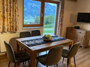 a dining room with a table and chairs and a window at Apartment with Alpine views in Fügenberg