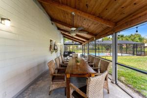 an outdoor dining room with a wooden table and chairs at 5665 S. Tropical Trail in Merritt Island