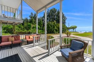 a porch with wicker chairs and tables on it at 5665 S. Tropical Trail in Merritt Island +92 photos