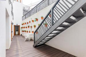 a staircase in a room with a table and chairs at Porta da Arrábida Suites in Palmela