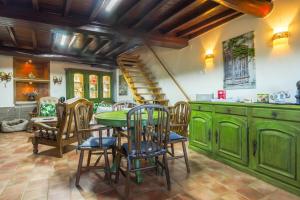 a kitchen with green cabinets and a table and chairs at Casa Mont'Santo with Balcony & Terrace in Monsanto