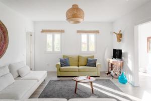 a living room with a couch and a table at Pinhal da Praia em Melides in Quinta da Cascalheirinha +35 photos