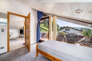 a bedroom with a bed and a large window at Studio Wacholderheide in Albstadt