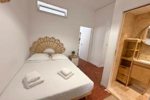 a bedroom with a bed with towels on it at Old Antibes 1 Bedroom 4 Persons in Antibes