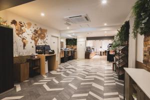 a store lobby with a checkered floor at Hotel NewNagano NeXT in Nagano +47 photos