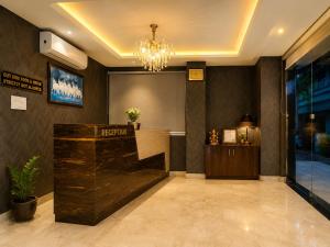 a hotel lobby with a reception desk and a chandelier at Hotel Karma Inn Near Akshay Patra Jagatpura in Jaipur +25 photos