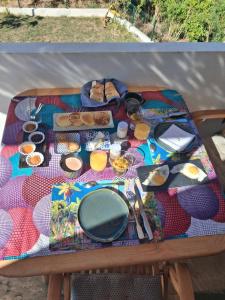 a picnic table with breakfast food on it at Mon Ti Kaz Canot in Petite Île +16 photos