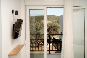 a door leading to a balcony with a view at White Nest Rooms in Potos