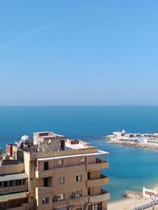 a building next to a body of water at Ibiza beach apartments in Alexandria