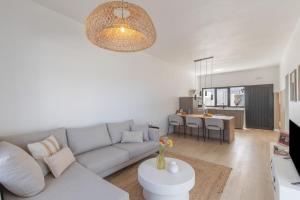 a living room with a couch and a table at Glück House In Las Norias in Las Manchas