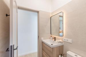 a bathroom with a sink and a mirror at Glück House In Las Norias in Las Manchas +18 photos