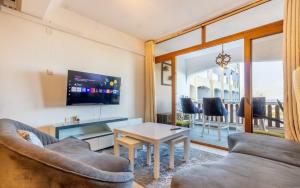 a living room with a couch and a table at Diani Beachfront by Bstan in Diani Beach