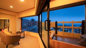 a living room with a large window with a view at Yururi Nishiizu in Ukusu