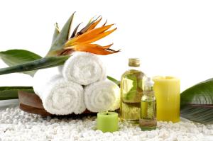 a pile of towels and candles on a table at The Pier Beach Inn & Suites in Willemstad