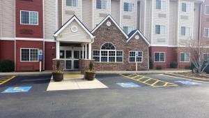 a parking lot in front of a building at Microtel by Wyndham Bentonville in Bentonville