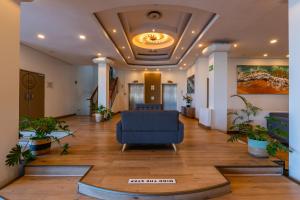 an office lobby with a blue chair in the middle at 419 Ocean Breeze in Cape Town