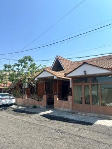 a house with a car parked in front of it at Gasparyan's Guest House in Pʼarakʼar