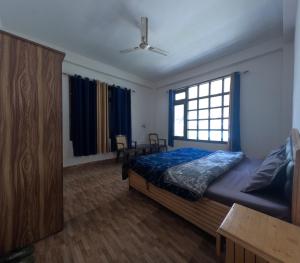 a bedroom with a bed and a window at The Pine View in Kasol