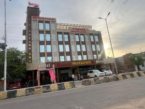 a large building on the side of a street at Hotel V Square in Lucknow