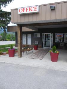 a office building with potted plants in front of it at Selkirk Inn in Golden