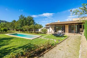 a backyard with a pool and a house at Alfonsa in Pollença