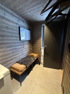 a small room with a bed and a door at Hafjell Luxury Lodge in Øyer