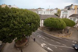 a man walking down a street with a tree at Hotel Venezuela in Villalba