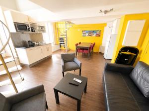 a living room with a couch and a table at Les Appartements Carré d'or - Nice Centre in Nice