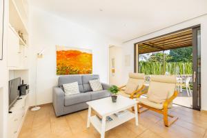 a living room with a couch and a table at Alfonsa in Pollença