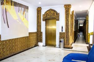 a hallway with a gold door in a building at Le Grand Palais Hotel in Phnom Penh